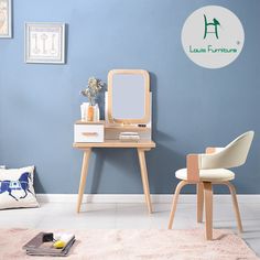 a small desk with a mirror and chair in a room that is painted light blue