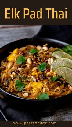 a bowl filled with noodles and garnished with cilantro, limes and peanuts