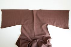 the top portion of a doll's brown dress