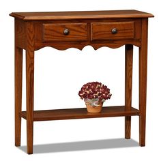 a wooden table with two drawers and a potted flower