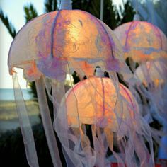 several jellyfish lights are hanging from the ceiling