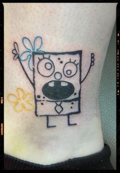 a cartoon character tattoo on the ankle