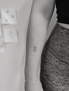 a woman with a small tattoo on her arm