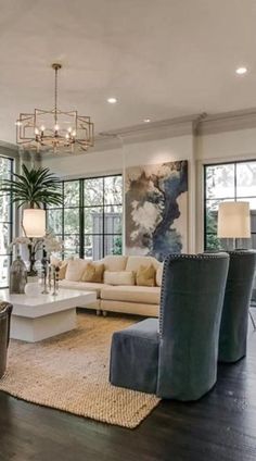 a living room filled with furniture and lots of windows