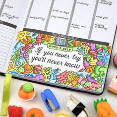 an open planner with colorful doodles on it and some other things to do in front of it