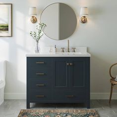 a bathroom with a sink, mirror and rug