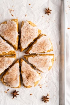 cinnamon sugar cookies arranged in a circle on top of parchment paper with star anise sprinkles