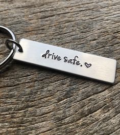 a metal keychain that says drive safe on it