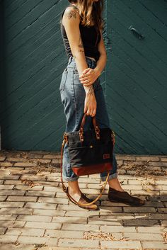 Pictured in our black waxed canvas and chestnut. A bag that feels familiar. Designed to be that perfect size, not too big, not too small. More structured and fit. Four interior and four exterior pockets keep things organized. Complete with handles and a cross body strap. Chloe Drew