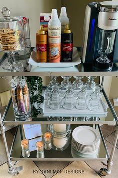 a glass shelf filled with dishes and drinks