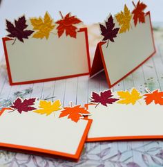 three cards with autumn leaves on them sitting next to each other and one has an empty card in the middle