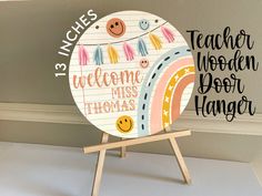 a wooden sign that says welcome to the teacher and mrs thomas hanger on a easel