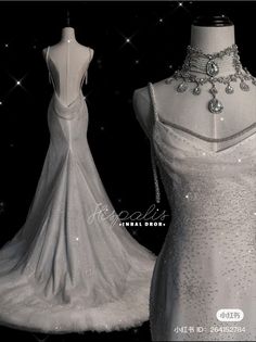 a white wedding dress on display in front of a black background