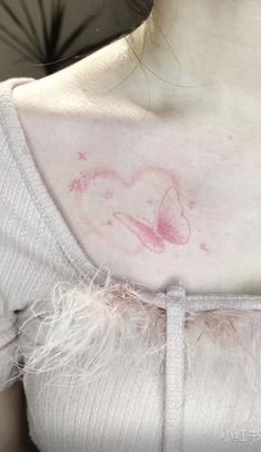 the back of a woman's chest with pink ink on it