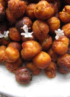 some kind of food that is on a white plate with flowers in the middle and one flower sticking out of it