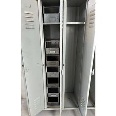 an empty metal storage cabinet filled with lots of drawers