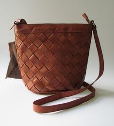 VILENCA HOLLAND TK164 CROSSBODY OR SHOULDER BAG COLOR: COGNAC CONSTRUCTED OF GENUINE LEATHER ADJUSTABLE CROSSBODY / SHOULDER STRAP 1 INTERIOR ZIPPERED COMPARTMENT 2 INTERIOR OPEN POCKETS  11.5" W X 10" H X 5"D NEW WITH TAG Cognac Woven Leather Bag, Daily Use Cognac Woven Leather Bag, Cognac Woven Leather Shoulder Bag For Travel, Cognac Woven Leather Bag For Everyday Use, Everyday Cognac Woven Leather Bag, Woven Leather Bag, Leather Work, Leather Tote Bag, Leather Working