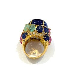 his is part of Chairish’s Fine Jewelry assortment.  Natural Blue Sapphire, Royal Blue Color, From Sri Lanka, Cabochon shape - 12 Carats   Carved floral Emeralds, Sapphires and Rubies - 6 Carats   White topaz - 1 Carat   This Ring is from the "Orient" traveling collection are the epitome of elegance and versatility. It offers a perfect blend of day to night and swimwear to evening wear, allowing you to effortlessly transition between different occasions and outfits. Wearing these spectacular orie Luxury Multi-stone Diamond Gemstones, Luxury Multi-stone Sapphire Gemstones, Multicolor Brilliant Cut Sapphire Ring For Formal Occasions, Luxury Multicolor Sapphire Ring For Formal Occasions, Multicolor Sapphire Ring For Formal Occasions, Luxury Multicolor Sapphire Ring, Formal Multicolor Round Sapphire Ring, Luxury Multicolor Cabochon Rings, Luxury Multicolor Sapphire Ring With Gemstone Accents