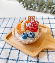 there is a small cake with fruit on it