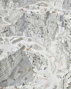 an aerial view of a quarry with construction equipment in the foreground and on the far side