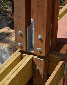 the bottom part of a wooden structure with two metal latches on each side and one door open