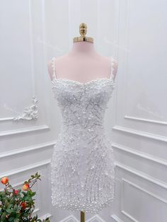 a white dress on a mannequin with flowers