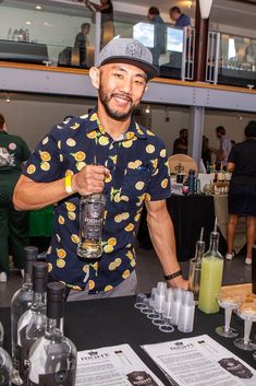 a man standing at a bar holding a bottle