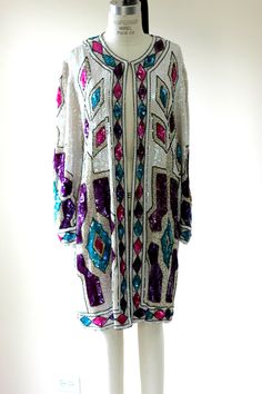 "Stunning Beaded Sequined duster by Judith Ann Creations. A big name in these types of coats. I love these coats. I think they are amazing!! This one has outstanding colors in bright purples, pinks and teal as well a gold and white beads and sequins. This has a hook and eye at the top. The rest is open. This is on 100% silk and then lined in Rayon. This is in very good condition. I see a few missing sequins, 3 at the most, and you really have to strain to see them. This is in such good shape!! T Bohemian Evening Outerwear With Long Sleeves, Vintage Beaded Long Sleeve Outerwear, Sequined Duster, Types Of Coats, Bright Purple, Long Jacket, Sequin Beading, Sequin Top, White Beads