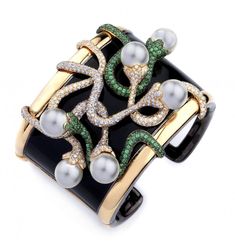 This 18K Yellow Gold Diamond Tsavorite Bracelet features unique yellow gold and black enamel highlighting pearls, Diamonds, and tsavorite to add sophistication and style. Tsavorite Garnet, Garnet Jewelry, Classy Jewelry, Cz Jewelry, Crocodiles, Enamel Bracelet, Elegant Bracelet, Bracelet Cuff, Bracelets Jewelry