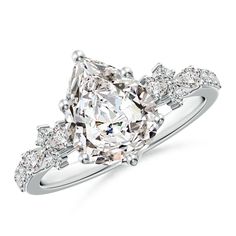 a cushion cut diamond ring with three stones on the band and shoulders, set in 18k white gold