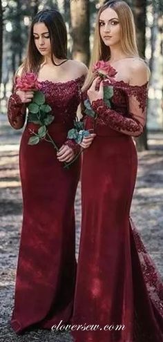 two women in red dresses standing next to each other and one is holding a rose