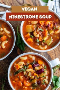 three bowls of vegan minestone soup on a wooden table