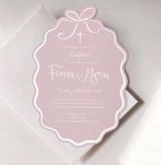 a pink and white wedding card with a cross on it