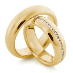 two yellow gold wedding rings with diamonds on each one and the other in between them