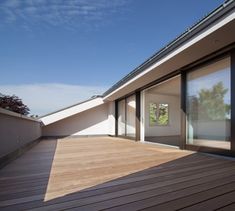 a wooden deck with sliding glass doors on it