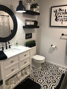 a white bathroom with black and white decor