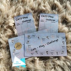 two cat's play challenge cards sitting on top of a furry surface with the text cats play challenge