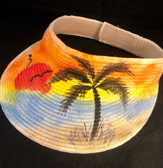 "Sun is shining  Classic Sun Visor for beach, hiking, pool alike  3.5\" deep with Velcro back strap - adjustable to most sizes from Small-to-XL Made from straw & paper braid, crushable/packable, SPF 50 in material Hand Painted Artwork - Paint to order Acrylic Paints used in artwork will not bleed if wet. Please allow for delivery times of 3-10 days. As this visor is custom made, there are no returns or exchanges but please contact me if there is a concern. Thanks much !! Enjoy" Adjustable Hand Painted Sun Hat For Summer, Hand Painted Adjustable Sun Hat For Summer, Adjustable Hand-painted Sun Hat For Summer, Summer Beach Sun Hat With Adjustable Strap, Adjustable Multicolor Sun Hat, Artistic Adjustable Sun Hat For Summer, Spring Beach Sun Hat Hand Painted, Adjustable Beach Sun Hat, Adjustable Multicolor Sun Hat For Summer