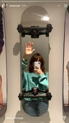 a woman taking a selfie in front of a mirror