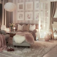 a living room filled with furniture and pictures on the wall