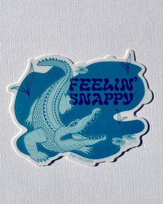 a sticker that says feeling snappy with an image of a crocodile on it