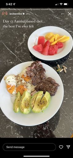 two white plates with food on them sitting on a counter top next to each other