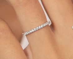 a woman's hand with a diamond ring on it