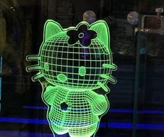 a lit up hello kitty figure sitting on top of a table