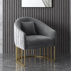 a gray chair with a gold base in front of a striped wall and a mirror