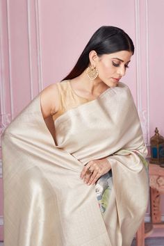 Beautiful beige floral Banarasi saree with zari border and pallu is a perfect drape for festive occasions. It comes with a blouse piece. Disclaimer: The shown stitched blouse on the model is for display purpose only. The saree comes with a matching blouse piece and finished with fall and piko. Festive Beige Blouse Piece With Traditional Drape, Designer Raw Silk Cream Saree, Designer Cream Raw Silk Saree, Designer Art Silk Saree In Cream, Designer Art Silk Cream Saree, Designer Cream Art Silk Saree, Traditional Drape Art Silk Blouse Piece In Cream, Cream Traditional Wear With Unstitched Blouse, Festive Beige Saree For Designer Wear