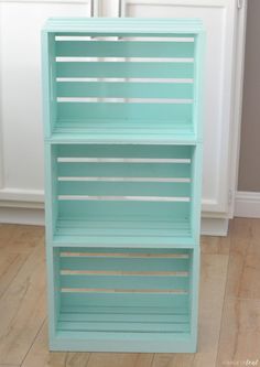 a blue book shelf sitting on top of a hard wood floor