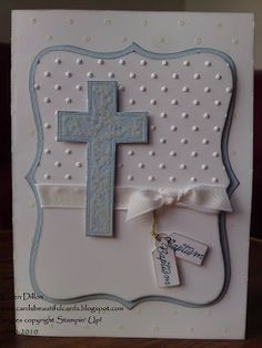 a card with a cross on it and some tags attached to the front of it