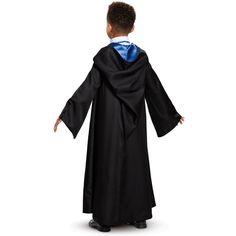 a young boy dressed in a black robe and blue stole standing with his hands on his hips