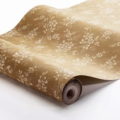 a roll of brown paper with white flowers on it